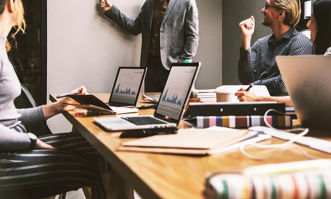 Group of business professionals discussing financial strategies in a modern office setting.